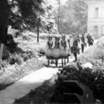 Girls walking down path in the rear of palace.